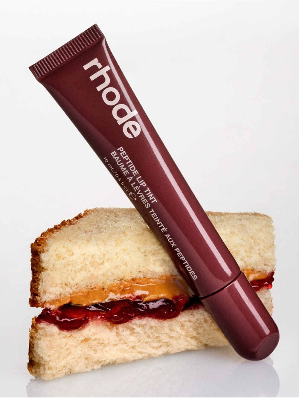 NIB rhode peptide lip tint in PBJ (warm berry brown)